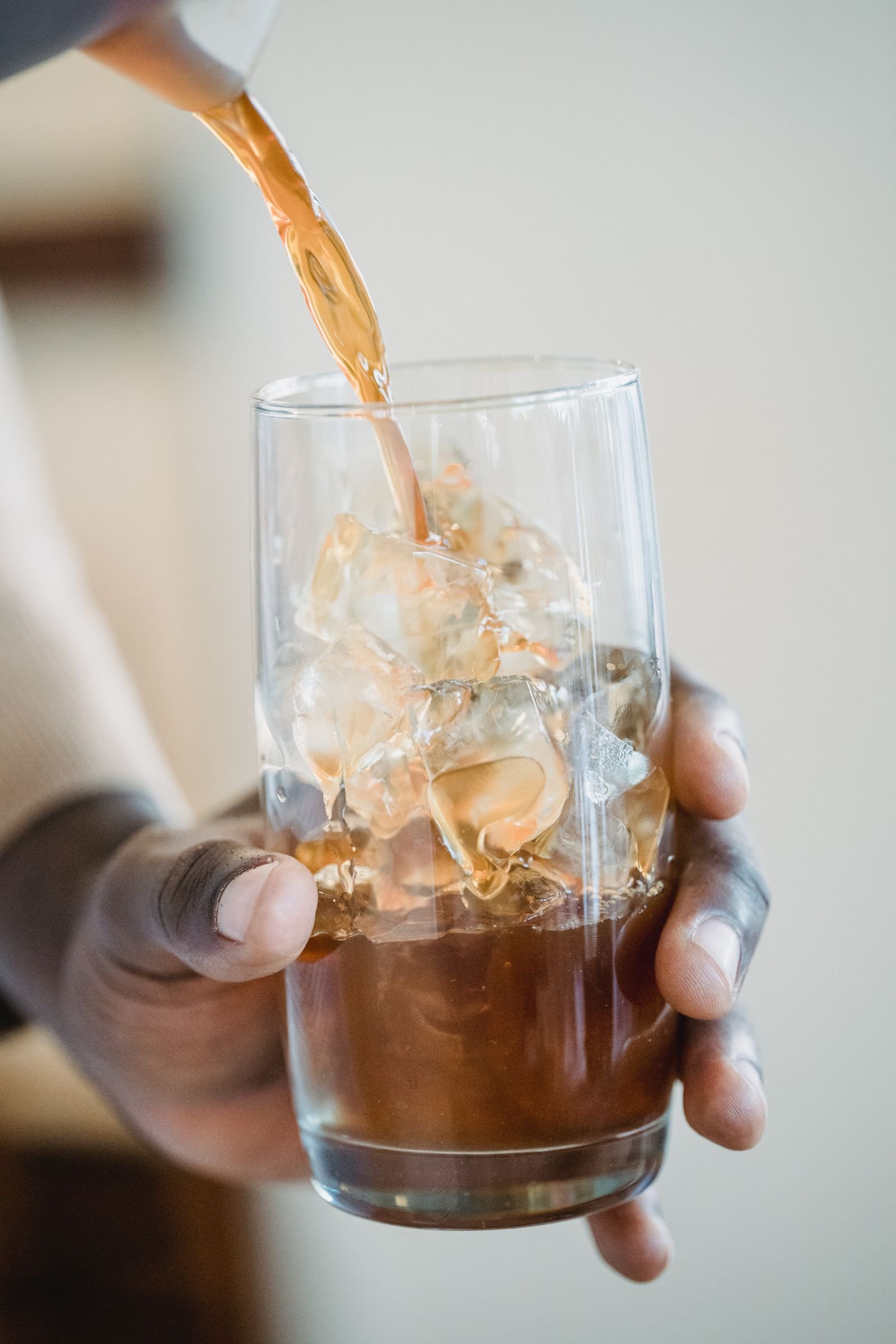 Cold milk poured into iced coffee